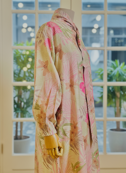 Mannequin wearing a floral dress with a blurred indoor background
